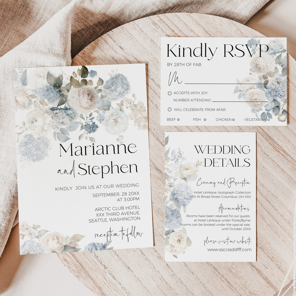 Wedding invitation set with floral design on a wooden surface