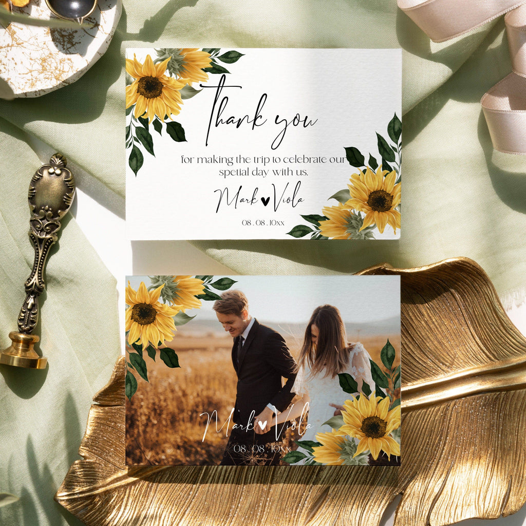 A tent folded thank you card with a floral design, featuring sunflowers, and a couple's photo on the front. The card has a 'Thank You' message and a signature line.
