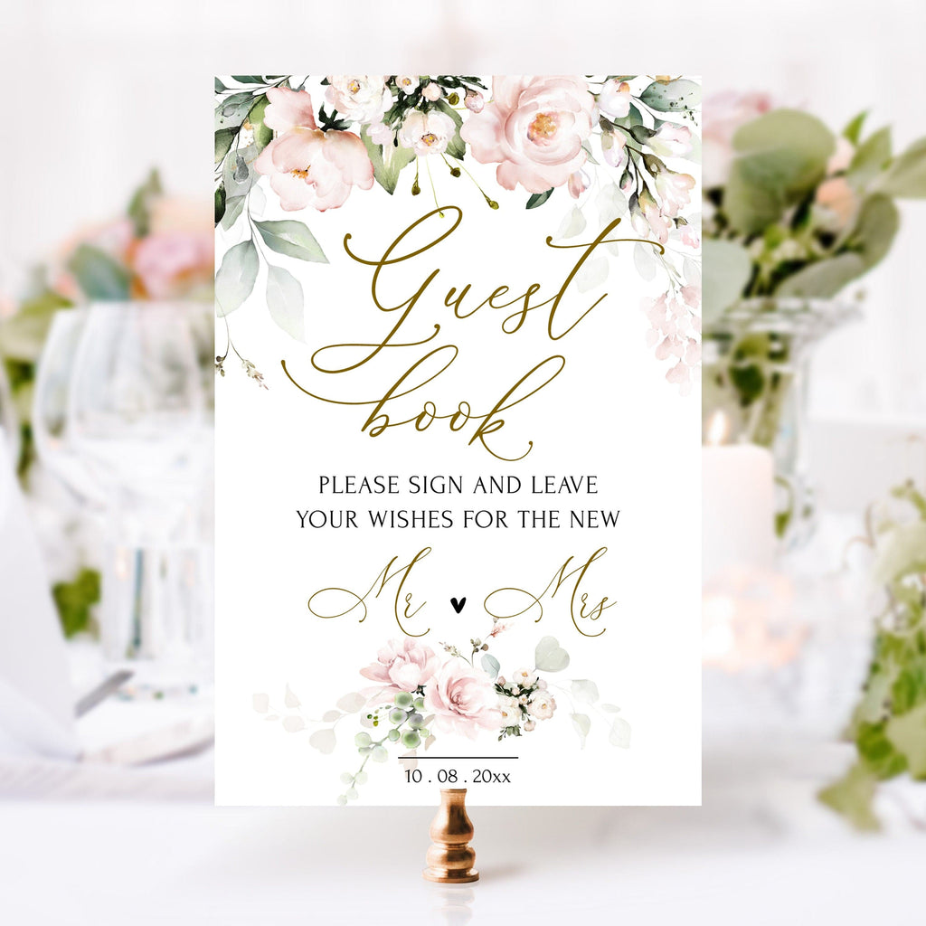 Guest book with floral design and wedding-themed text on a white background