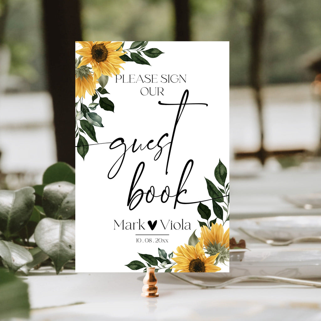 A printable wedding guest book sign with floral design, featuring sunflowers and leaves, and space for personalization with text and images.
