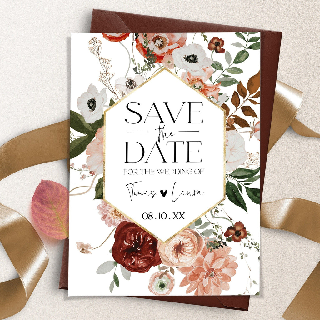 A save the date card with a floral design featuring burnt orange and terracotta flowers.