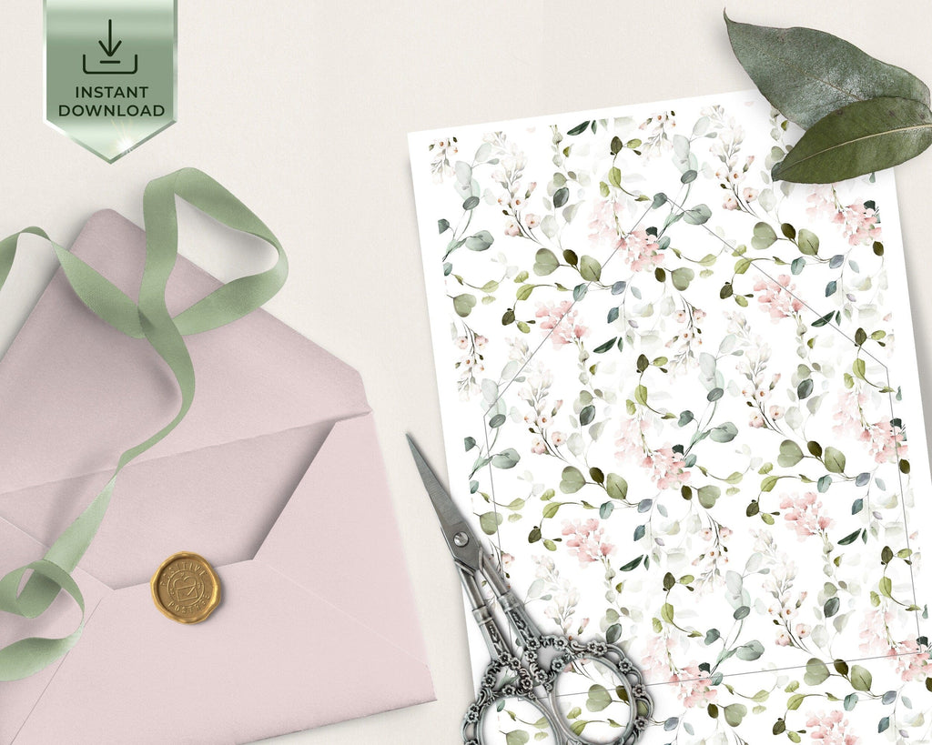 Floral patterned paper with a pink envelope, green ribbon, and scissors on a light background.