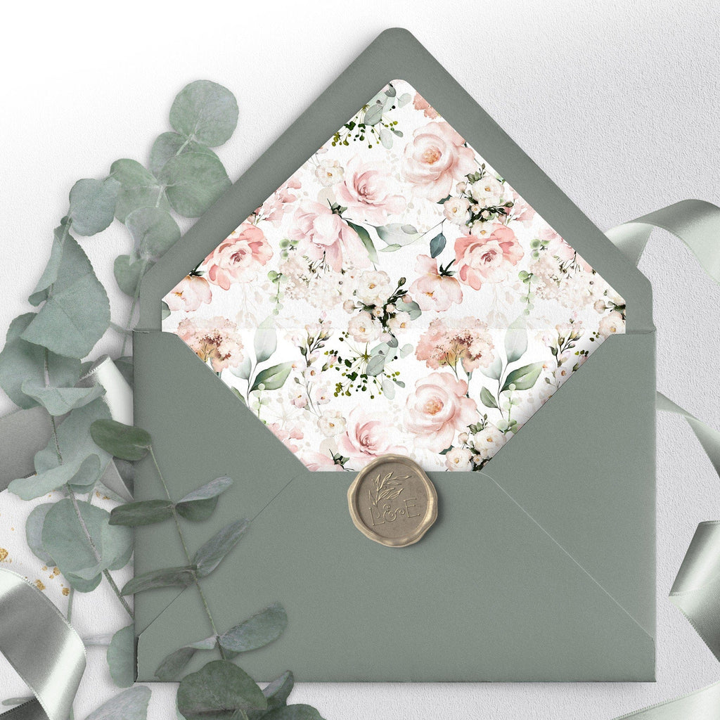 A green envelope with a blush floral liner and a wax seal stamp on the front.