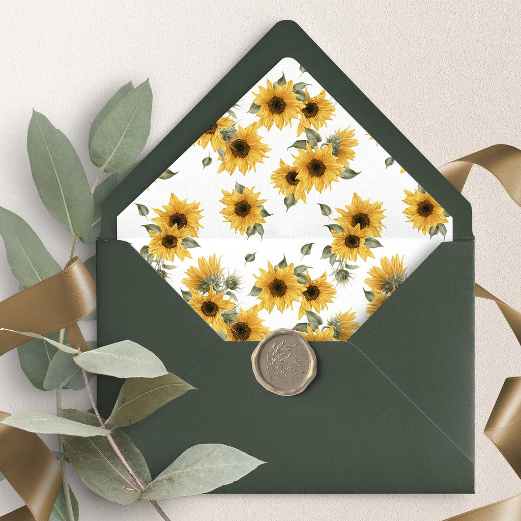 A green envelope liner with a sunflower pattern displayed inside a larger green envelope, with a wax seal stamp on the front.