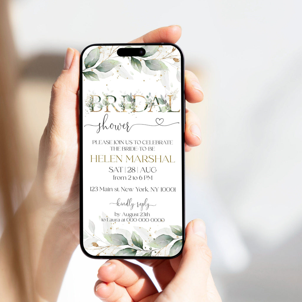 A digital bridal shower invitation displayed on a smartphone, held in a person's hands. The invitation has a green and gold color scheme with floral elements and text.