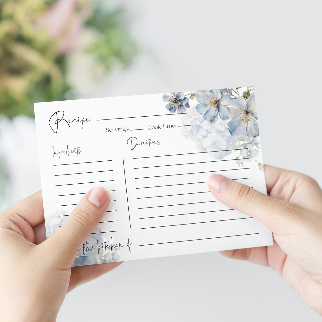 Person holding a recipe card with floral design