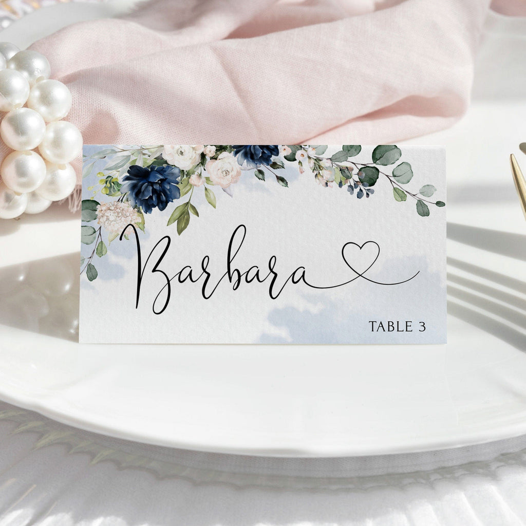 Place card with navy and blush floral design and name 'Barbara' on a white plate.