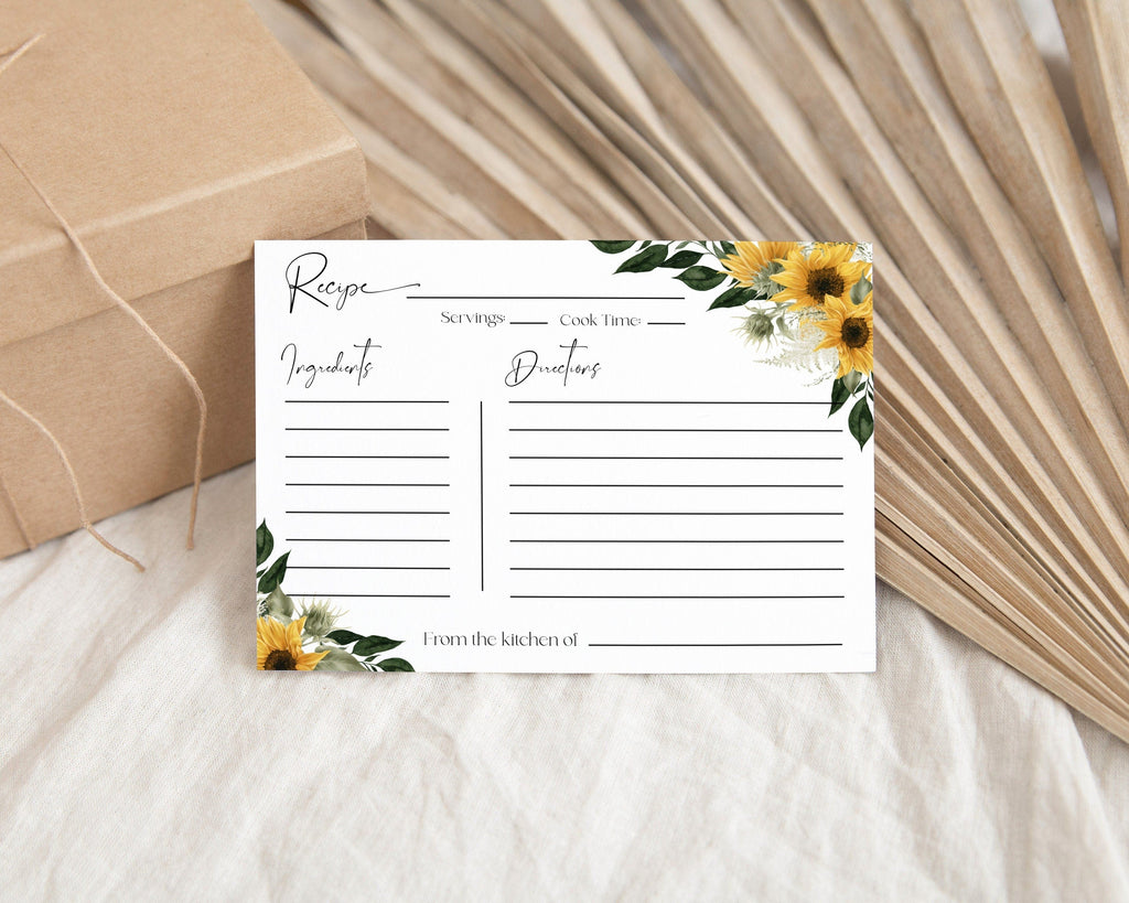 Editable recipe card with a floral border and sunflower design, displayed on a table with a cardboard box and decorative leaves in the background.