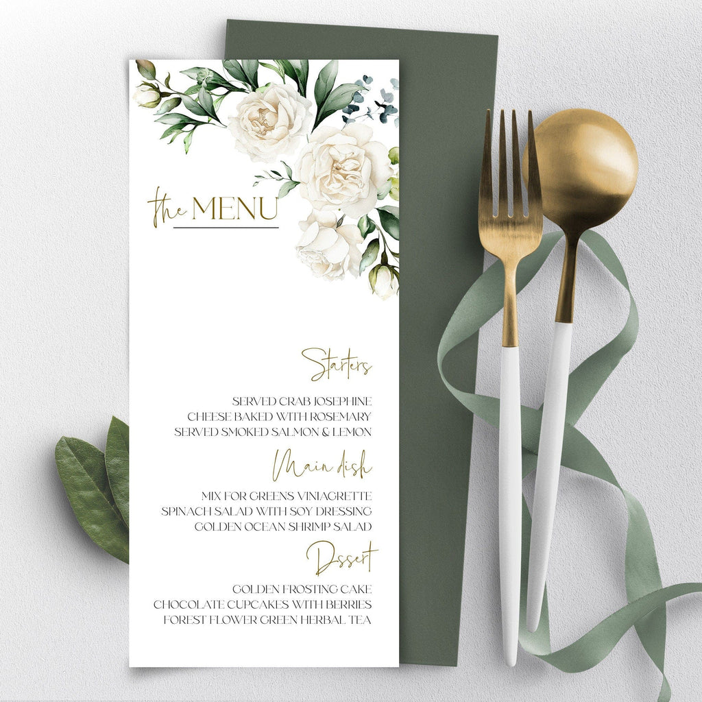 A printable wedding menu card with a floral design featuring creamy white flowers and gold accents, placed on a table with a golden fork and green leaves.