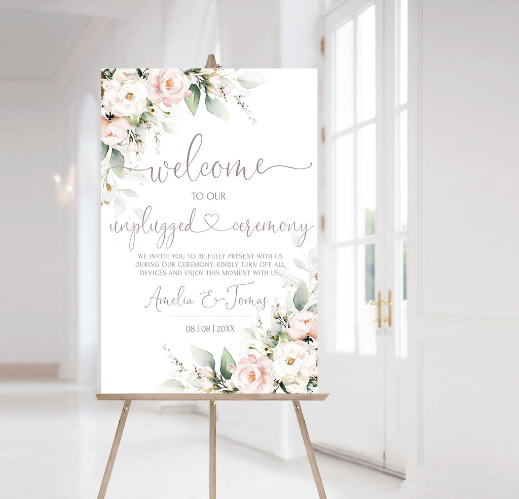 A stand-up pink welcome sign with floral design and customizable text, displayed in a room with a white background.