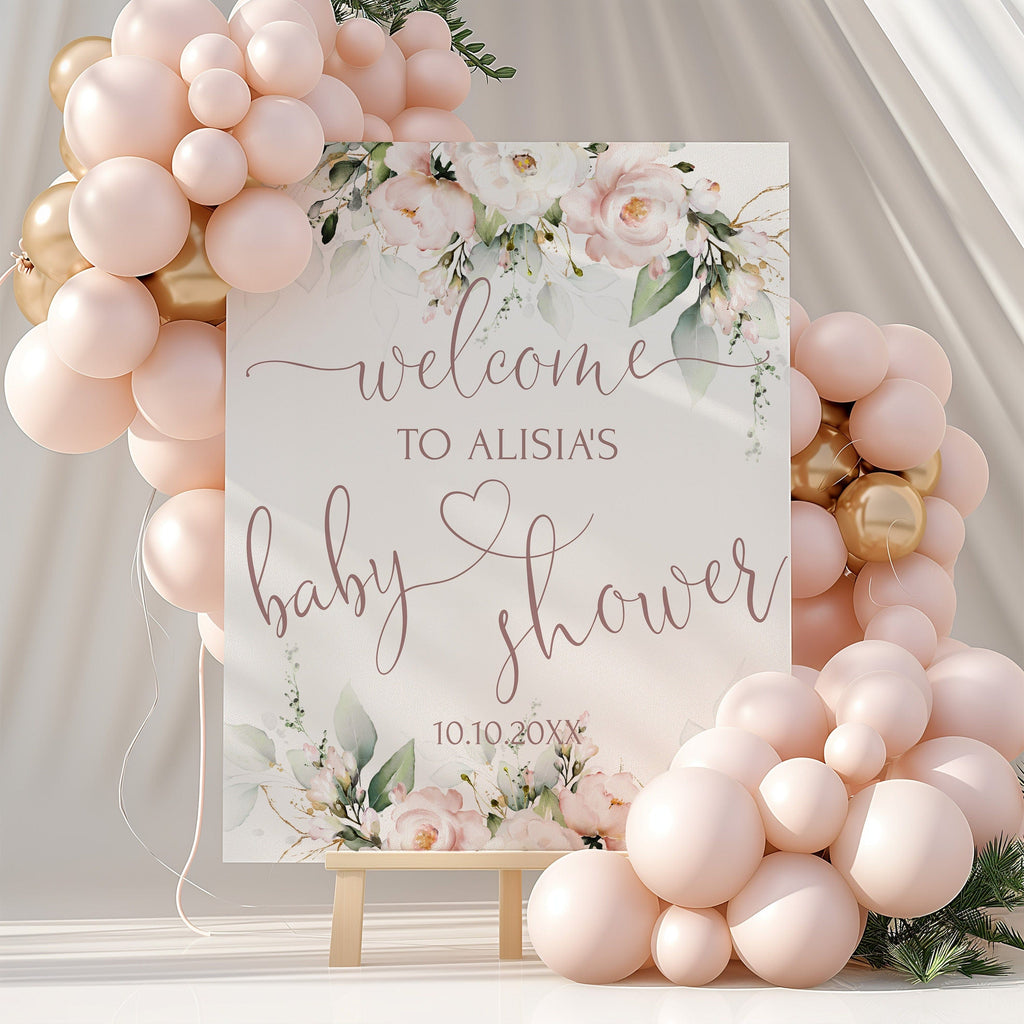 A blush pink baby shower welcome sign with floral design and customizable text, displayed amidst balloons.